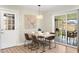 Cozy dining area with wood floors, a modern light fixture, and a sliding glass door to the outdoor patio at 7520 E Diamond St, Scottsdale, AZ 85257
