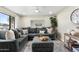 Spacious living room with a large sectional sofa, ottoman, area rug, and decorative accents at 7520 E Diamond St, Scottsdale, AZ 85257