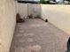 Enclosed backyard featuring a stone pathway, rock landscaping, and neutral colored stucco wall at 7808 E Lewis Ave, Scottsdale, AZ 85257