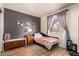 Inviting bedroom features a quilt, wooden chest, natural light, and modern decor at 7808 E Lewis Ave, Scottsdale, AZ 85257