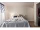 Well-lit bedroom with a decorative quilt, soft lighting, and a calm atmosphere at 7808 E Lewis Ave, Scottsdale, AZ 85257