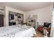 Bright bedroom with walk-in closet, open shelving, natural light, and a cozy reading nook at 7808 E Lewis Ave, Scottsdale, AZ 85257