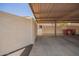 A covered carport offers convenient parking with easy access to the home, seen with garbage cans at the back at 7808 E Lewis Ave, Scottsdale, AZ 85257
