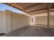 The carport has a textured wall and metal roof, offering a shaded parking space and entry to the home at 7808 E Lewis Ave, Scottsdale, AZ 85257