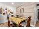 Cozy dining room featuring a wood accent wall and seating for four at 7808 E Lewis Ave, Scottsdale, AZ 85257