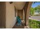 Cozy front porch featuring brick arches, teal chair, and views of the neighborhood at 7808 E Lewis Ave, Scottsdale, AZ 85257