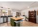 Bright kitchen with wooden island, stainless appliances, and a view to the backyard at 7808 E Lewis Ave, Scottsdale, AZ 85257