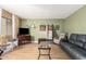 Living room with laminate floors, green walls, and comfortable seating arrangements at 7808 E Lewis Ave, Scottsdale, AZ 85257