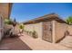 Private patio area with brick flooring, a table set with umbrella, and access gate for outdoor enjoyment at 7808 E Lewis Ave, Scottsdale, AZ 85257