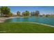 Picturesque pond surrounded by lush grass and mature trees at 7808 E Lewis Ave, Scottsdale, AZ 85257