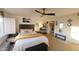 Bright bedroom with a ceiling fan, comfortable bedding, and a glimpse of the ensuite at 7860 E Camelback Rd # 404, Scottsdale, AZ 85251