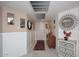 Bright entryway features white wainscoting, and decorative accents like mirrors, plants, and console tables at 7860 E Camelback Rd # 404, Scottsdale, AZ 85251