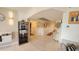 Hallway with light tile flooring, decorative mirrors, wall paneling, and access to other rooms at 7860 E Camelback Rd # 404, Scottsdale, AZ 85251