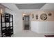 Hallway with patterned tile flooring, white wainscoting, and decorative accents like mirrors and plants at 7860 E Camelback Rd # 404, Scottsdale, AZ 85251