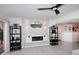 Bright living room featuring sleek shelving, modern fireplace, and unique lighting fixtures at 7860 E Camelback Rd # 404, Scottsdale, AZ 85251