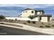 An exterior street view showing a landscaped front yard and white brick fence at 820 W Lark Dr, Queen Creek, AZ 85140