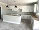 Bright kitchen features white cabinets, modern pendant lighting, and a functional island at 820 W Lark Dr, Queen Creek, AZ 85140