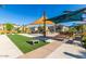 Inviting amenity area with picnic tables, benches, artificial grass and shade canopies offers a relaxing outdoor gathering space at 8313 E Impala Ave, Mesa, AZ 85209