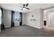 This room offers neutral walls, carpet, and a ceiling fan to complete the airy design at 8313 E Impala Ave, Mesa, AZ 85209
