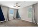 This bedroom features neutral walls, carpet, and two windows which allow for ample light at 8313 E Impala Ave, Mesa, AZ 85209