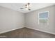 This room offers neutral walls, carpet, and a ceiling fan to complete the airy design at 8313 E Impala Ave, Mesa, AZ 85209