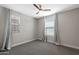This bedroom features neutral walls, carpet, and two windows which allow for ample light at 8313 E Impala Ave, Mesa, AZ 85209