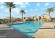 Sparkling community pool with lounge chairs and palm trees offers a resort-style living experience at 8313 E Impala Ave, Mesa, AZ 85209