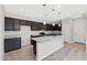 Modern kitchen with dark wood cabinets, granite countertops, and stainless steel appliances at 8313 E Impala Ave, Mesa, AZ 85209