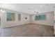 A spacious living room features large windows, a ceiling fan, and light neutral walls at 8313 E Impala Ave, Mesa, AZ 85209