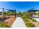 Scenic view of the community playground featuring various play structures and lush landscaping at 8313 E Impala Ave, Mesa, AZ 85209