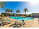 Community pool surrounded by palm trees and lounge chairs, creating a resort-like atmosphere at 8313 E Impala Ave, Mesa, AZ 85209