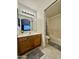 Neutral bathroom design featuring a single vanity, a large mirror, and a shower-tub combo at 8874 N 48Th Ln, Glendale, AZ 85302
