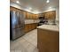 Well-maintained kitchen featuring stainless steel appliances, oak cabinets, and tile flooring at 8874 N 48Th Ln, Glendale, AZ 85302