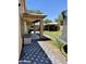 Spacious backyard with a large covered patio, barbecue area, green lawn, and a gazebo at 10426 W Roanoke Ave, Avondale, AZ 85392