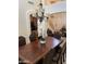 Formal dining room featuring wainscoting, an elegant chandelier, and seating for six people at 10426 W Roanoke Ave, Avondale, AZ 85392