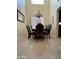 Elegant dining room with tile flooring, large window, chandelier, and dining table set for eight at 10426 W Roanoke Ave, Avondale, AZ 85392