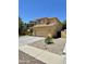 Exterior view of home showcasing a desert landscape, a driveway, and a two-car garage at 10426 W Roanoke Ave, Avondale, AZ 85392