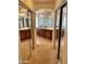 Large bathroom featuring a dual vanity, walk-in shower, neutral tile flooring and a huge walk in closet at 10426 W Roanoke Ave, Avondale, AZ 85392