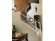 Sweeping staircase with iron spindles and a carpet runner leading to the upper level at 10426 W Roanoke Ave, Avondale, AZ 85392