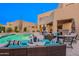 Outdoor patio with comfortable seating, a grill, and a view of the pool at 10772 E Running Deer Trl, Scottsdale, AZ 85262