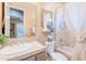 Cozy bathroom featuring a shower-tub combination, neutral tile and stone countertop at 10772 E Running Deer Trl, Scottsdale, AZ 85262