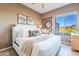 Bright primary bedroom featuring light hardwood floors, neutral walls, and a beautiful desert view at 10772 E Running Deer Trl, Scottsdale, AZ 85262