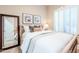 Comfortable bedroom featuring a wood frame bed, plantation shutters, and neutral decor at 10772 E Running Deer Trl, Scottsdale, AZ 85262