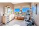 Bright bedroom featuring light hardwood floors, neutral walls, and a beautiful desert view at 10772 E Running Deer Trl, Scottsdale, AZ 85262