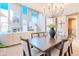 Open-concept dining area with high ceilings, adjacent to a cozy living space and staircase at 10772 E Running Deer Trl, Scottsdale, AZ 85262