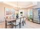 Elegant dining room with a chandelier, wine cooler, and desert-themed artwork at 10772 E Running Deer Trl, Scottsdale, AZ 85262