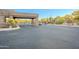 Gated community entrance featuring stone accents and desert landscaping, offering privacy and security at 10772 E Running Deer Trl, Scottsdale, AZ 85262