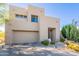 Desert home with neutral color palette, two-car garage, and native vegetation at 10772 E Running Deer Trl, Scottsdale, AZ 85262