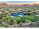 Expansive golf course view with lush green fairways, a pond, sand traps, and mountain views in the background at 10772 E Running Deer Trl, Scottsdale, AZ 85262