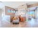 Bright hallway with hardwood floors, accent furniture, and entry to a bedroom at 10772 E Running Deer Trl, Scottsdale, AZ 85262